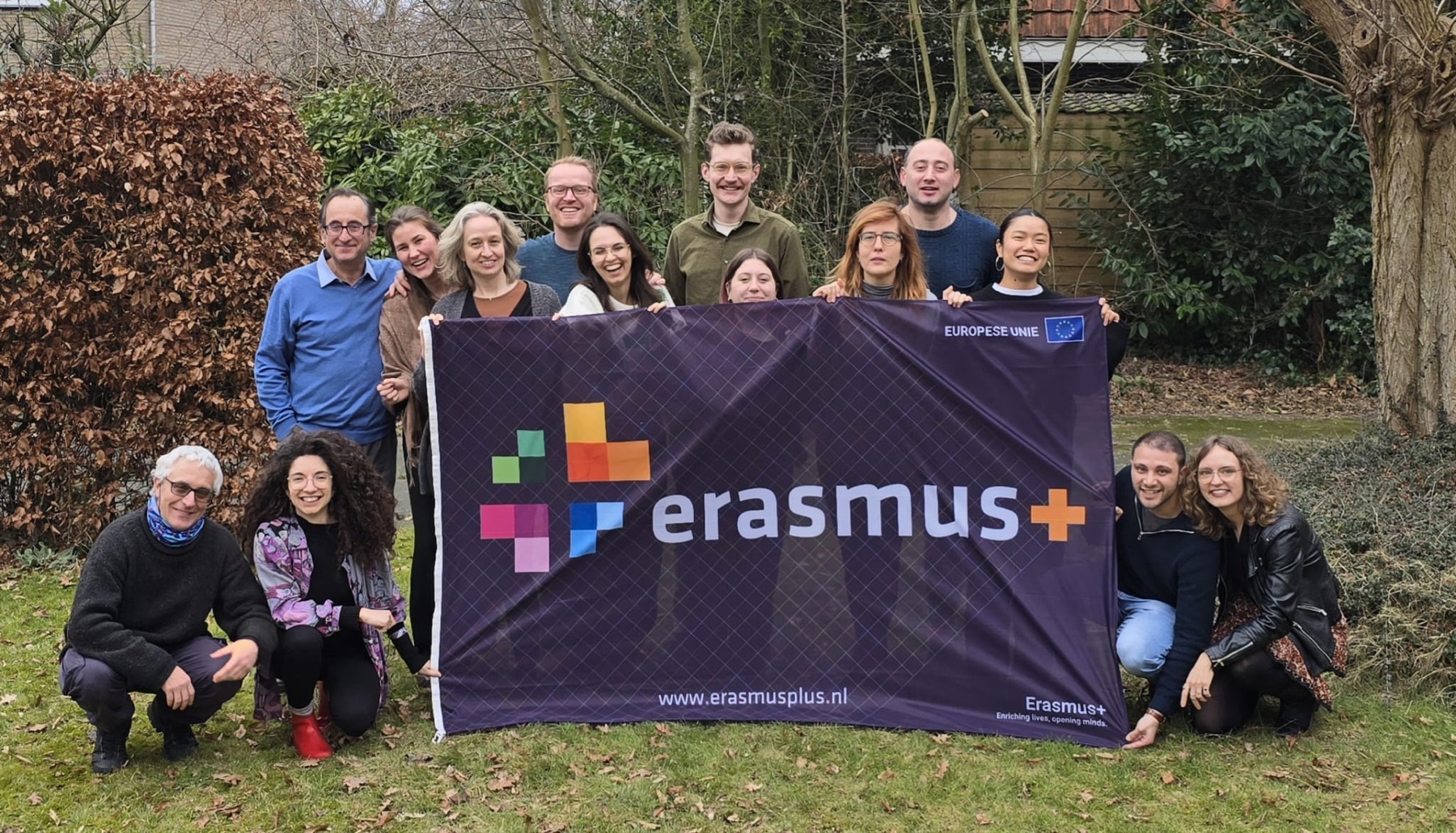 Participants holding an Erasmus+ banner during the Visibility Meeting in Meppel
